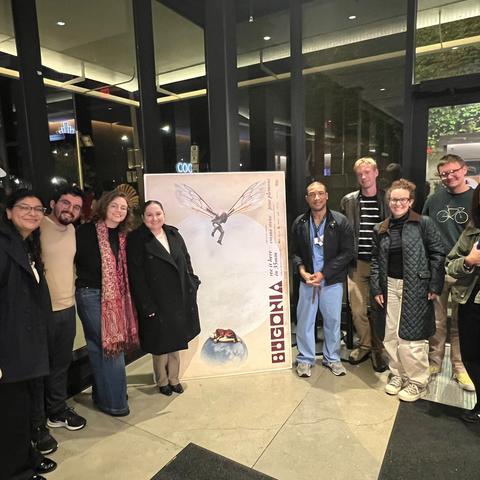 HSSPA members around the poster for the premiere of the film Bugonia.